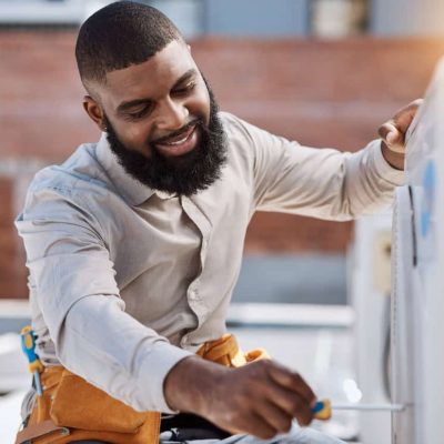 Building, engineer and air conditioner install with a black man on a roof for construction or manual labor. Industrial, engineering and an electrician working on ac repair for maintenance or service.