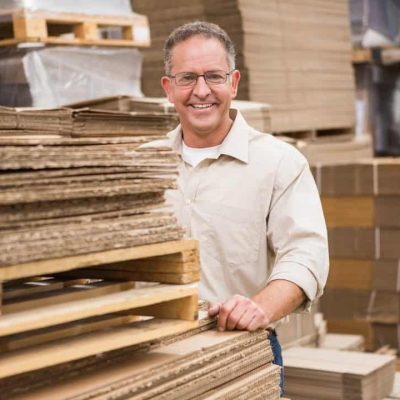 Portrait of smiling warehouse worker in a large warehouse